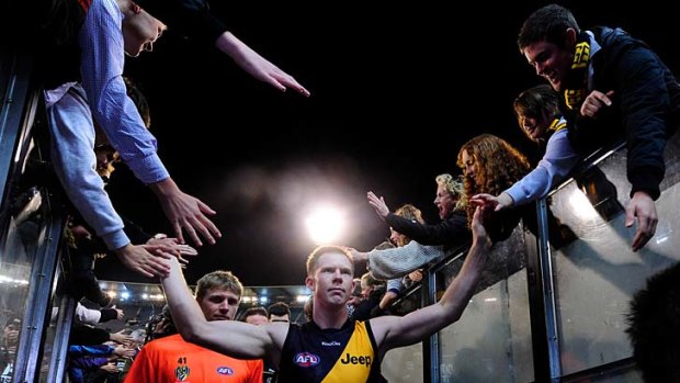 Shining light: Jack Riewoldt high-fives fans after the Tigers' 29-point win over Sydney at the MCG.