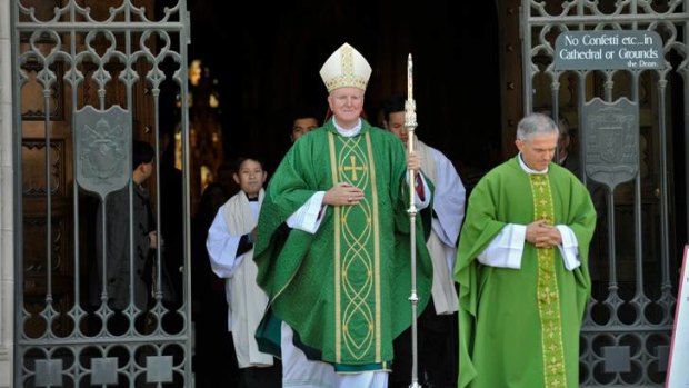 Archbishop Denis Hart leaves St Patrick's Cathedral after celebrating Mass on Sunday.