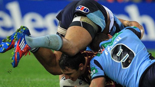 Billy Slater gets buried under two Blues.