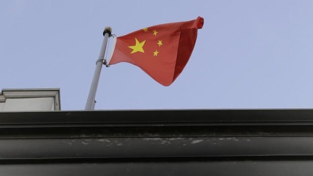 The flag of China flies over the damaged entrance of the Chinese Consulate in San Francisco.