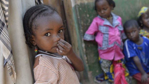 A young girl waits to receive medical aid northeast of Bangui.