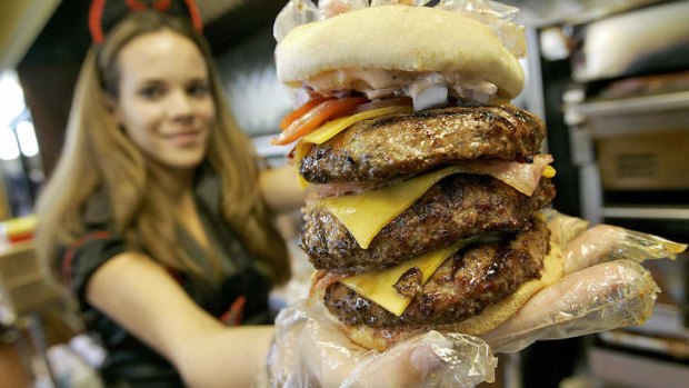 Calorific ... a waitress holds one of the  Heart Attack Grill's triple-bypass burgers.