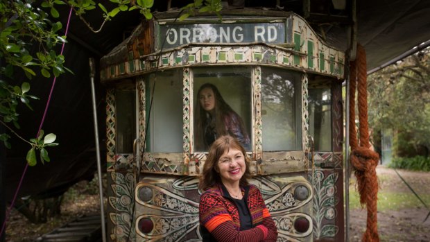 Anita Castan (front) and her daughter Karina with Mirka Mora's art tram on the family's Mt Eliza property.