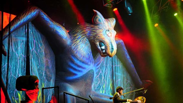 A giant bat with lasers coming from its eyes hovers over the stage.