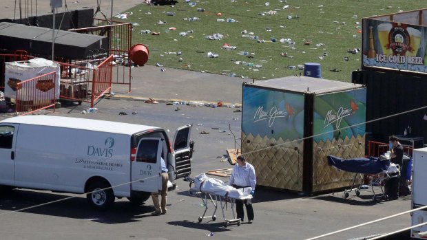 Investigators load a body from the scene of the mass shooting near the Mandalay Bay resort and casino in Las Vegas.