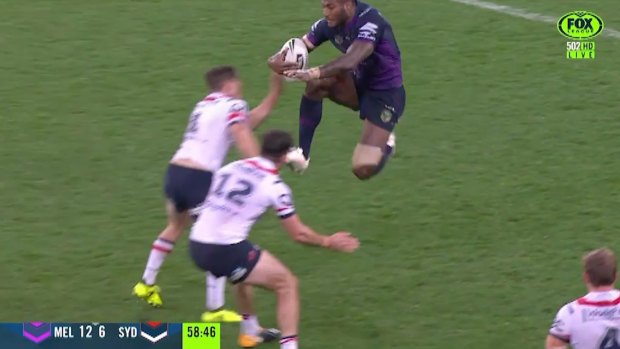 'How do you comment on that?' Melbourne's Suliasi Vunivalu leaps with his knees at the Roosters defenders.