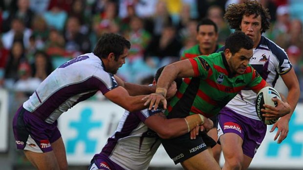 Facing the fury: Greg Inglis of the Rabbitohs is tackled by Storm players.