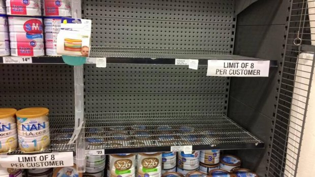 A Woolworths shelf emptied of popular Australian brands. It has imposed an eight-tin limit.