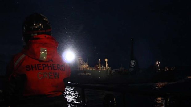 A searchlight beams from a Japanese whaling ship at Sea Shepherd activists aboard the Bob Barker.