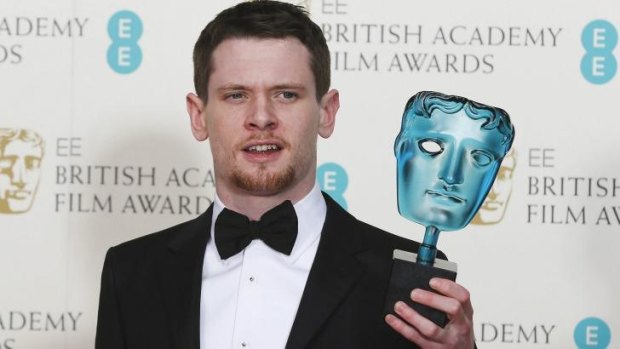Jack O'Connell celebrates after winning the best rising star award at the BAFTAs.