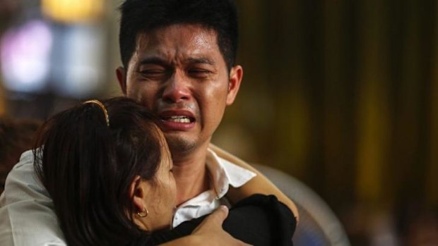 The father of a pair of siblings killed in a Bangkok bomb blast mourns during their funeral.