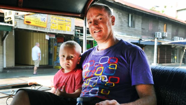 Australian traveller Shane Pearce with his son, Finn, in Khao San road, Bangkok, a popular location for tourists.
