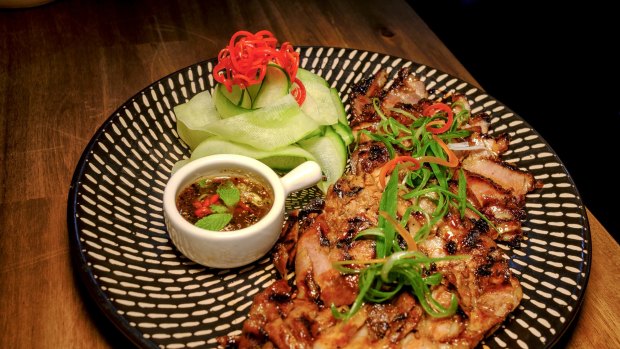 Kor Moo Yang, or char-grilled pork neck, from a large bracket of sticky grilled meats on the menu.
