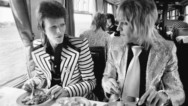 May 14, 1973, Bowie with his intrepid guitarist Mick Ronson (aka Ronno) having a British Rail lunch on the train to Aberdeen at the beginning of his final Ziggy Stardust tour. ''At this time David would not fly anywhere, says photographer Mick Rock. ''Trains and boats were the only travel means they would use. I love the conspiratorial look between them. Like they have a tiger by the tail! Which of course they did. The British music scene would never be the same.''