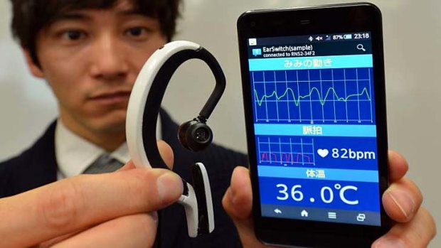 An engineer of Japanese machinery maker NS West shows the 'Earclip-type Wearable PC'.