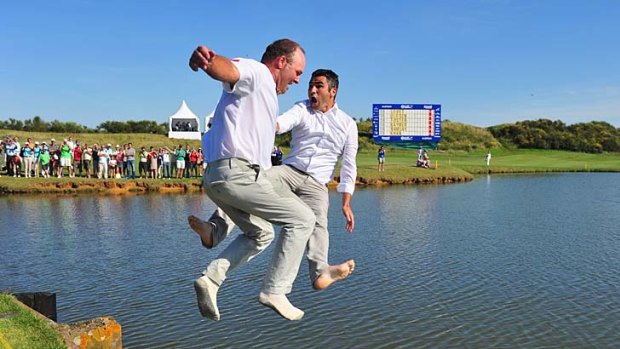 The fateful jump ... Thomas Levet (left) and his manager leap into the lake.