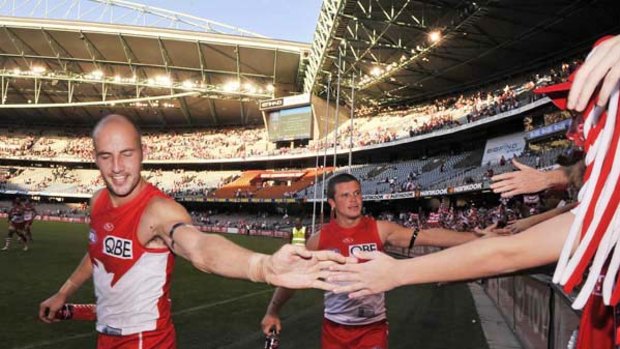 Tadhg Kennelly celebrates with supporters after the Swans' 40-point win over North Melbourne at Etihad Stadium.