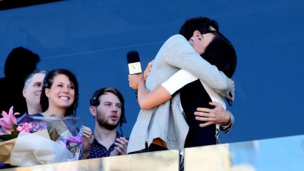 Let's hug it out ... Wake Up hosts James Mathison and Natarsha Belling on the final show at Manly Beach.
