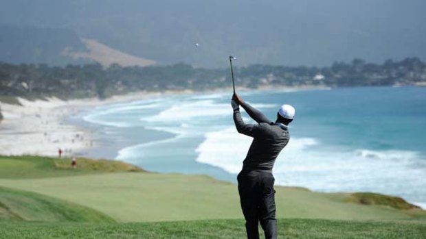 Losing his grip ... Tiger Woods plays his second shot to the ninth at Pebble Beach. He made bogey at the hole on his way to a three-over 74.