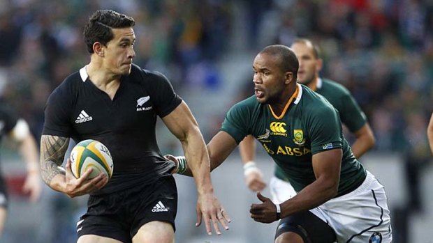 Harassed ... Sonny Bill Williams of New Zealand is tackled by JP Petersen of South Africa.