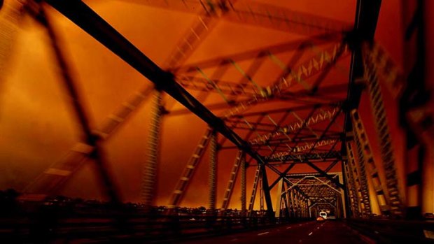Looking ugly: Smoke and dust obscure the Tom Uglys Bridge in southern Sydney.