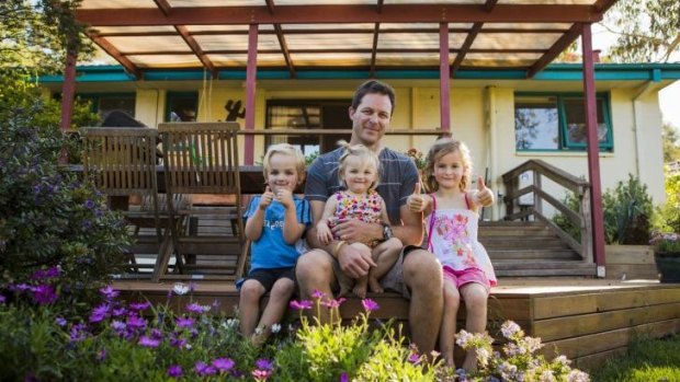 Moving on: Mr Fluffy homeowner Forrest Koch with his three children (from left) Martin 4, Peggy 16 months, and Hanna 5.  Mr Koch bought a new home on Saturday at auction.