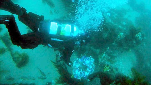 Dive Victoria's Josh Clark lays a wreath on the wreck of HMAS Goorangai to mark the 73rd anniversary of the ship's sinking.