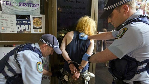 Mean streets: Police arrest a man in Kings Cross as police seek powers to test violent offenders for alcohol and drugs.