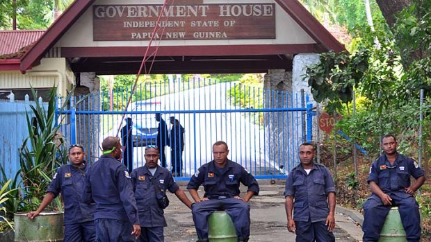 Power tussle ... Papua New Guinean Police prevent Prime Minister Peter O'Neill and his supporters from reaching Government House in Port Moresby on Tuesday.