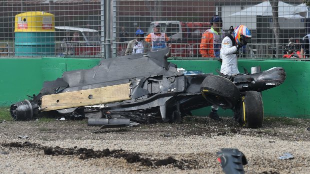 Fernando Alonso emerges from the wreck of his car after he collided with Esteban Gutierrez.