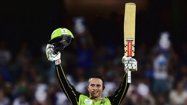 In form: Usman Khawaja raises his bat after scoring his century against the Strikers in Thursday's Big Bash semi-final.