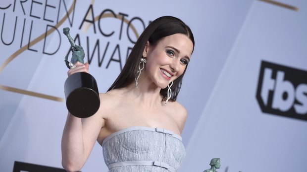 Rachel Brosnahan poses with the awards for outstanding performance by a female actor in a comedy series and outstanding performance by an ensemble in a comedy series for The Marvelous Mrs. Maisel.