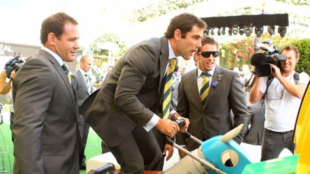 Ride 'em ... Cameron Smith plays a video game at the barrier draw for the Victoria Derby yesterday.