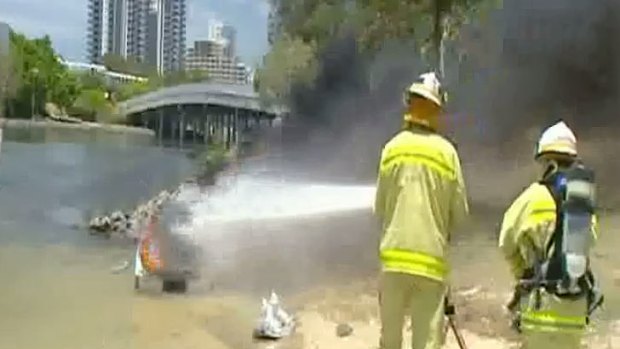 Firefighters douse a jet ski after it exploded.