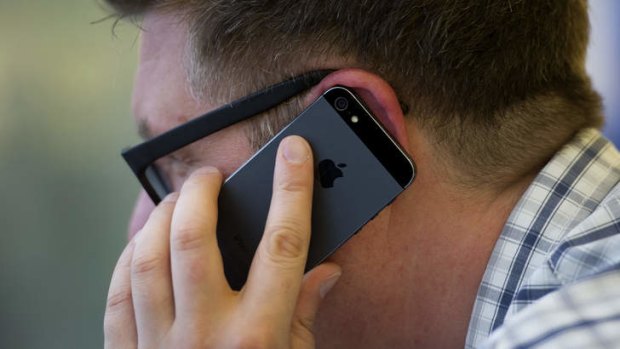 A man uses an Apple iPhone. Samsung says Apple has refused to pay licensing fees for its patents.