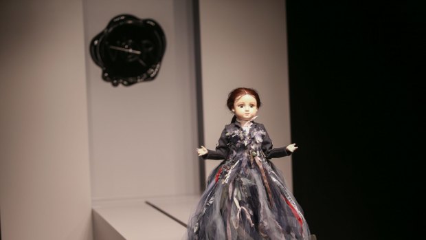 A miniature mannequin traverses the runway at the NGV.