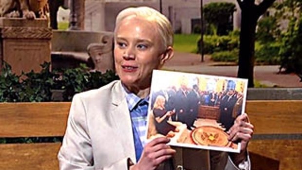 Kate McKinnon holds up the now infamous photo of Kellyanne Conway perched on an Oval Office couch. 