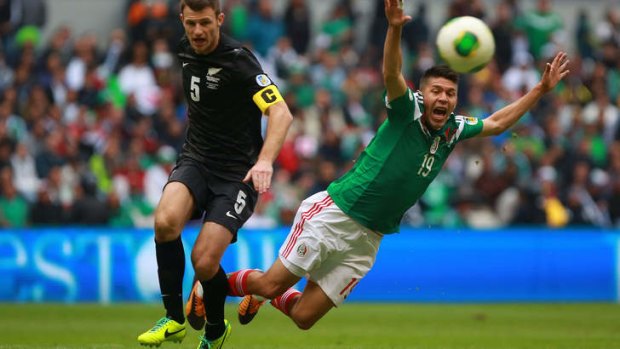 Oribe Peralta of Mexico appeals for a free kick against Tommy Smith of New Zealand.