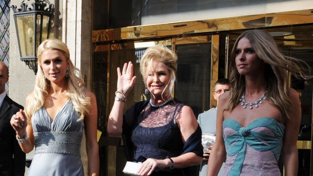 Paris Hilton, left, her sister Nicky, right, and their mother Kathy Hilton, centre, head for the wedding.