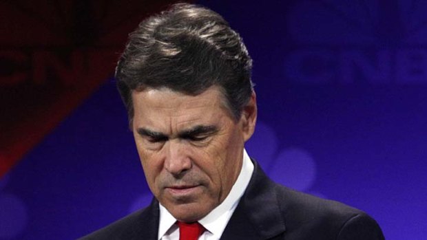 Whoops ... Rick Perry looks at his notes after making his blunder.
