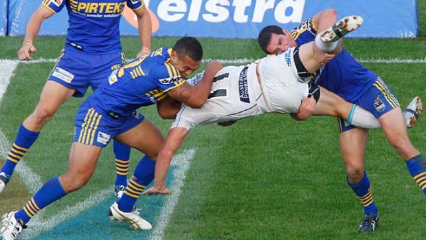 Resilient ... Parramatta’s Taniela Lasalo and Daniel Mortimer slam Titans’ back-rower Greg Bird to the ground during an impressive defensive effort by the Eels at home yesterday.
