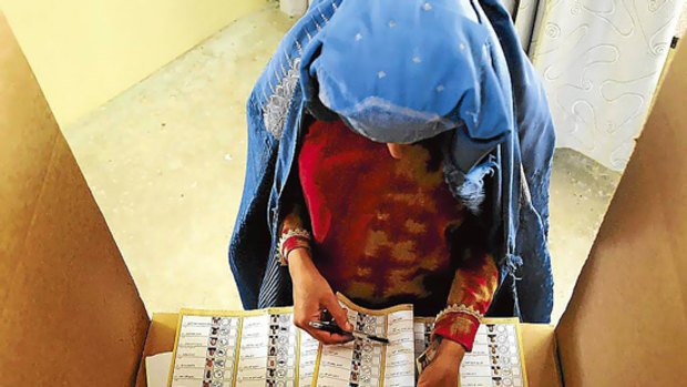 A woman votes in Afghanistan's August election.