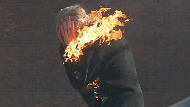 A protester is engulfed in flames during clashes with police on Tuesday.