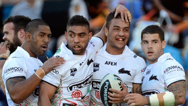 Happy days ... Dylan Farrell of the Rabbitohs celebrates with team mates after scoring.