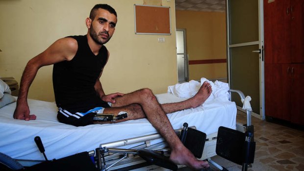 Syrian opposition fighter Ali Ahmed in his hospital bed in Lebanon. His right leg was shattered during the battle for Qusayr.