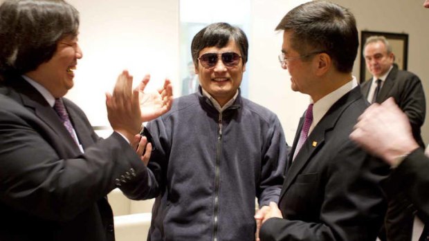 Blind activist Chen Guangcheng shakes hands with the US ambassador to China Gary  Locke in May.