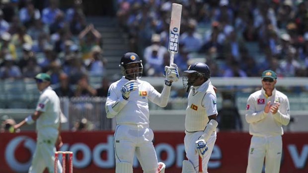 Kumar Sangakkara raises his bat at the MCG on Boxing Day to acknowledge the applause after he became the 11th player to reach 10,000 Test runs.
