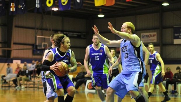 Norths player Andrew Martin and Wests player Chris Hartmann in action in the grand final.