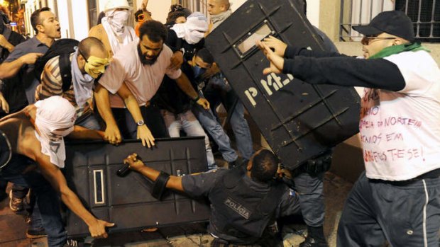 Demonstrators clash with riot police during a protest in front of Rio de Janeiro's Legislative Assembly building in Rio de Janeiro.