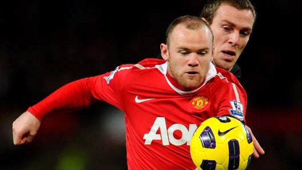 Wayne Rooney of Manchester United beats Richard Dunne of Aston Villa to score after just 50 seconds of play.